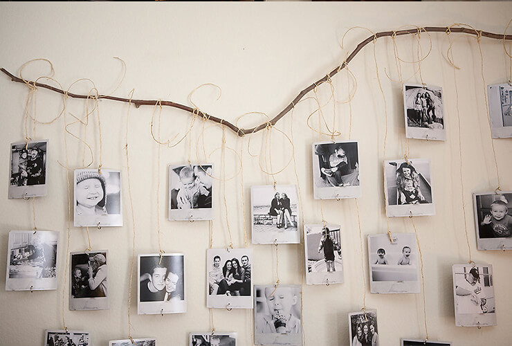 Photos hanging from a piece of wood